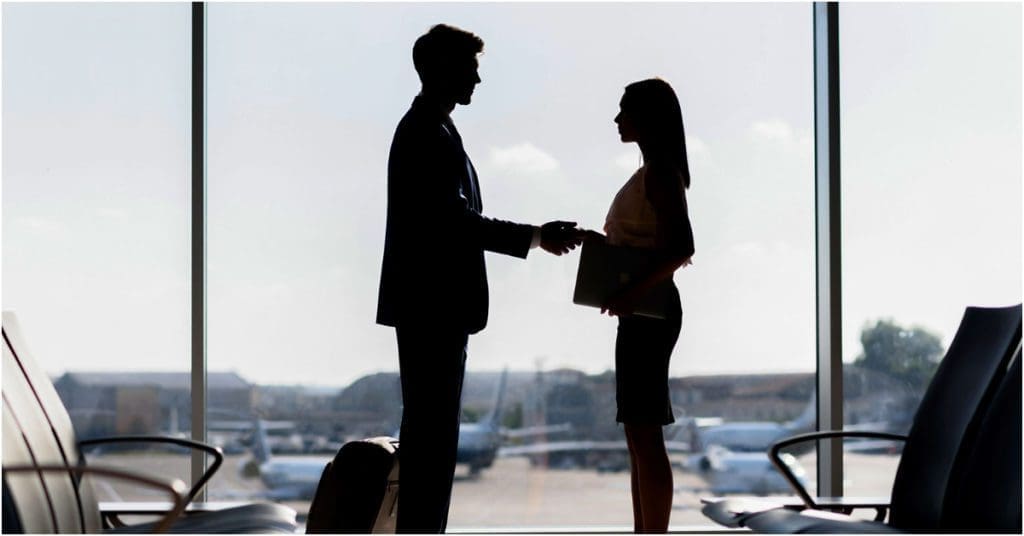 man and woman shaking hands in airport, 5 steps to get hired faster in your dental career, dental career